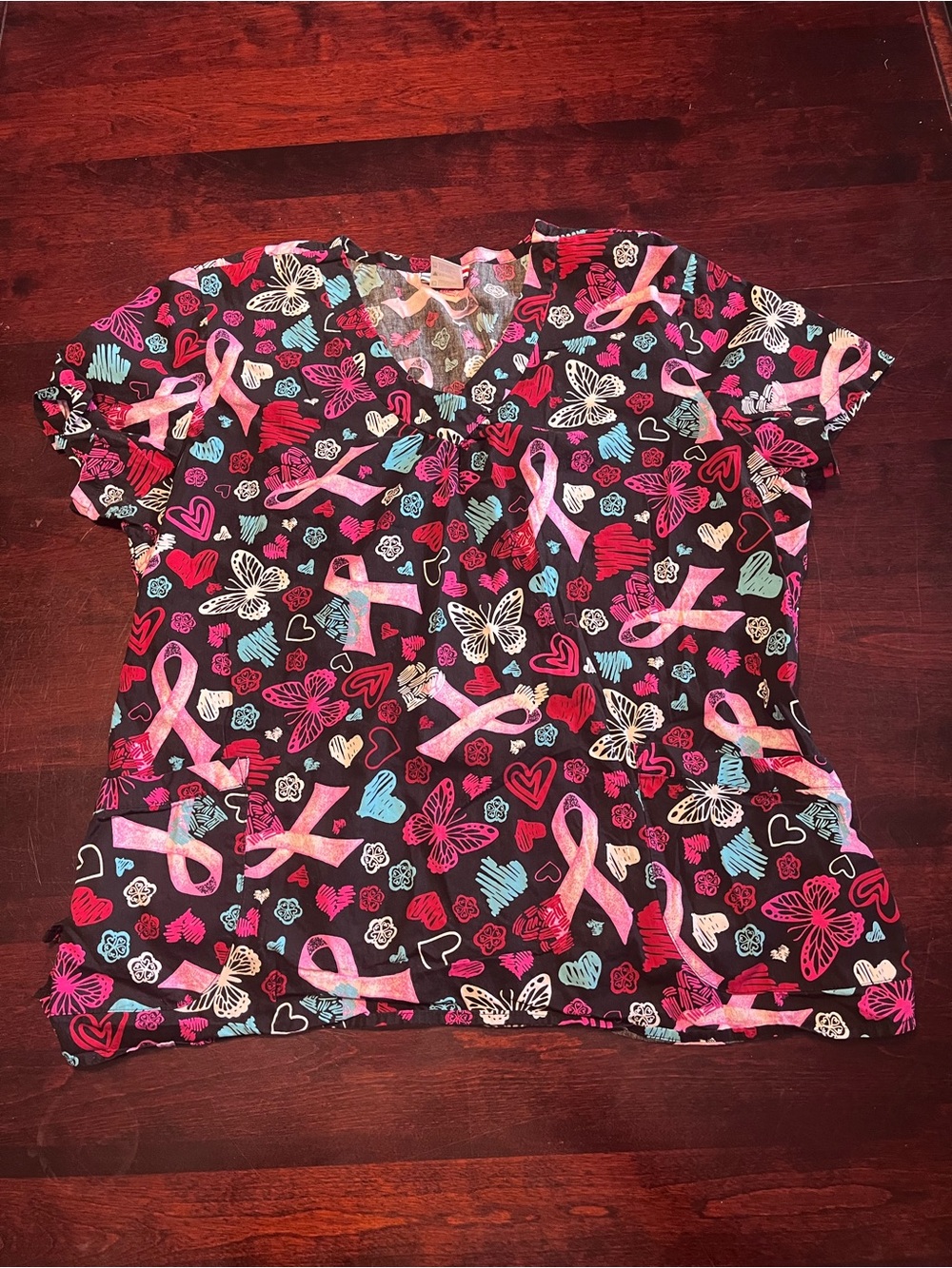 Women’s white cross scrub top with pink ribbons and butterfly’s